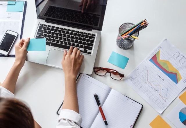 Person Using Laptop With Sales Reporton Desk 850x584 2